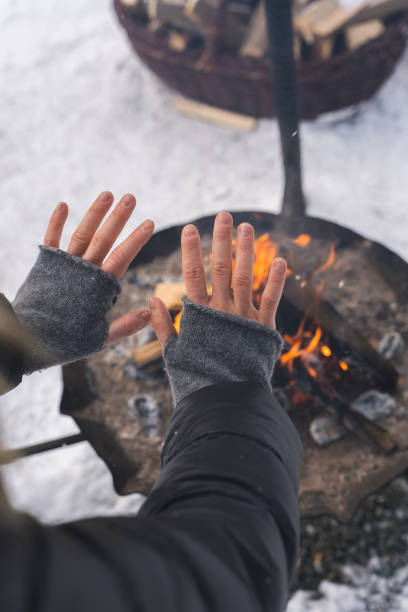 istock Woman warming up her hands by the fire pit 1344756066