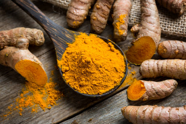 istock Curcuma longa, powder and rhizomes 1344757200