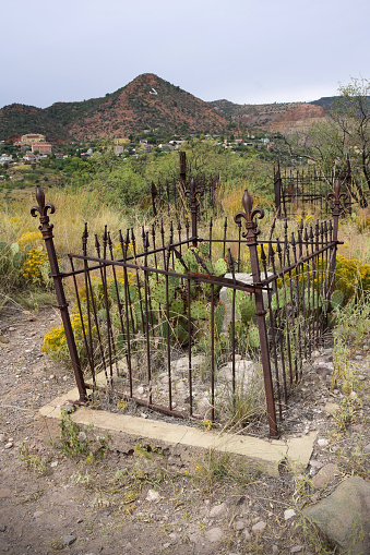 The historic old miner's cemetery on Boot Hill in Jerome, Arizona with view of the old hillside mining town in the background.