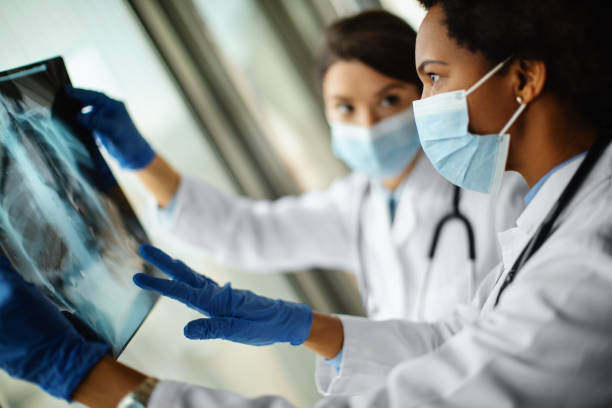 istock Doctors analyzing an x-ray image of a COVID-19 patient. 1344759213