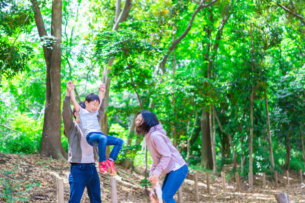 istock Family playing in the forest 1344759296