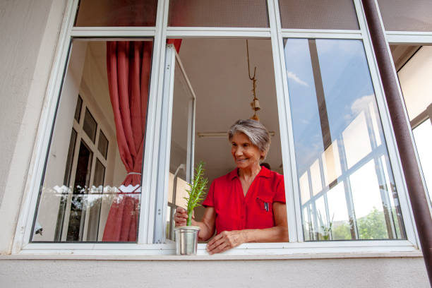 The woman is trying to open the glass garden door.