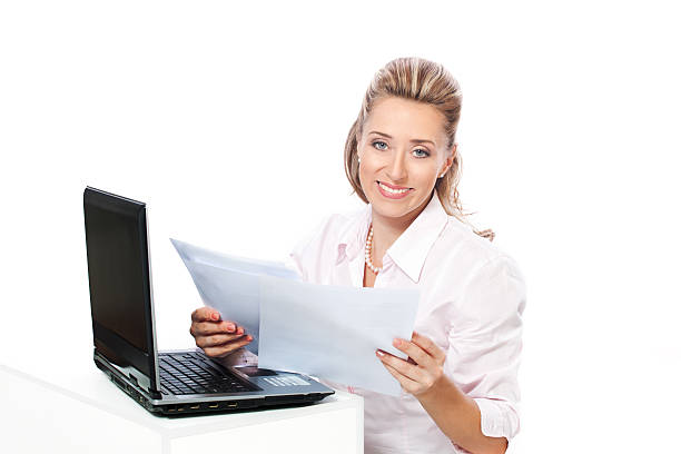 istock Smiling business woman doing paperwork 134476185