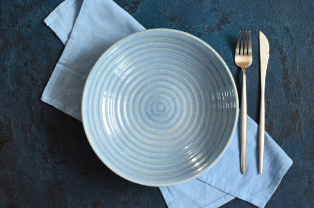 istock empty clean ceramic plate top view and napkin with copy space for text and dissign, dish template for food. 1344762641