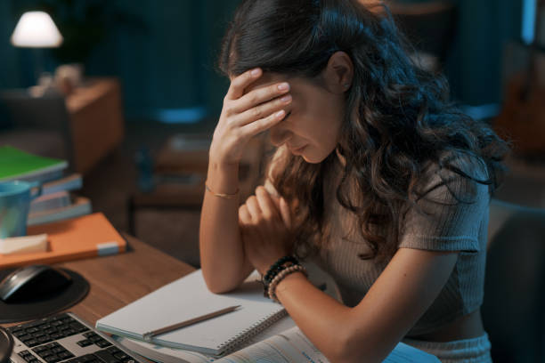 istock Depressed stressed woman sitting at desk 1344763016