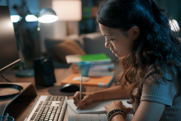 istock Smart young woman studying late at night 1344763766