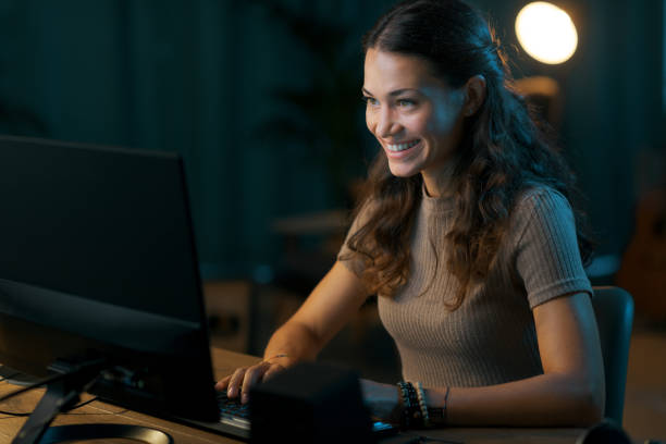 istock Happy young woman connecting online at night 1344763882