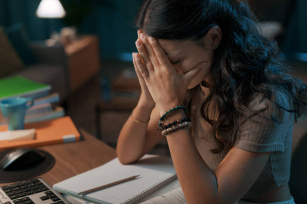 istock Depressed stressed woman sitting at desk 1344763938
