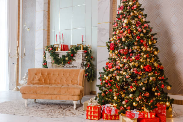 istock large Christmas tree with red and gold balls and fireplace 1344764186