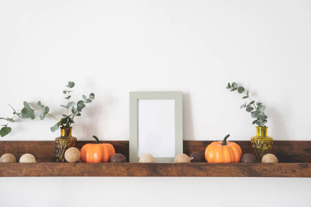 istock White mock up picture frame on brown shelf 1344764874