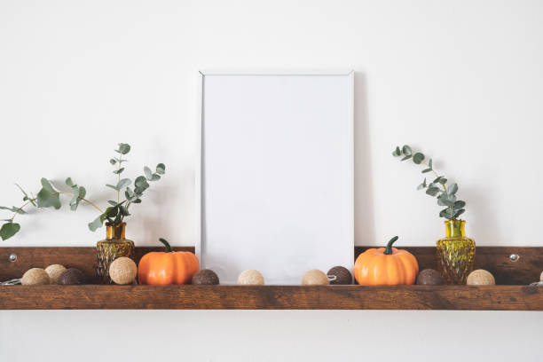 istock White picture frame with copy space on brown shelf 1344764883
