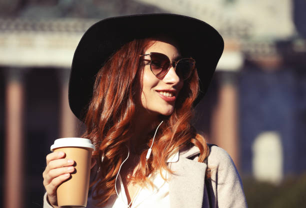 istock Smiling stylish young woman drinking coffee 1344766326