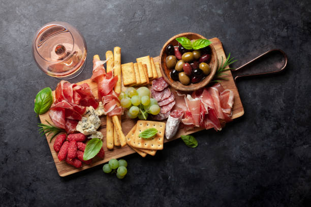 istock Antipasto board with prosciutto, salami, crackers, cheese, olives 1344766903