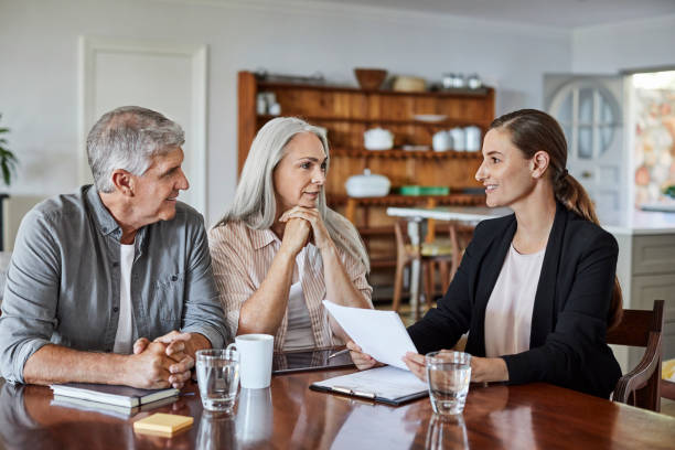 istock Mature couple with financial advisor at home 1344767013