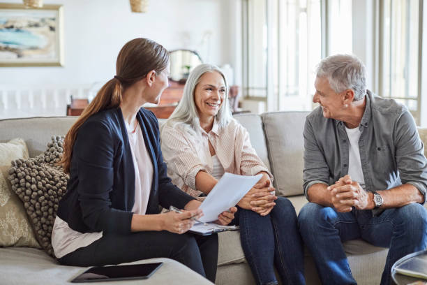 istock Happy couple with financial advisor at home 1344767055