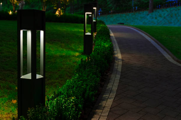 Photo of evening square decorative lantern light on promenade area with small footpath trail in garden with beautiful electricity lights