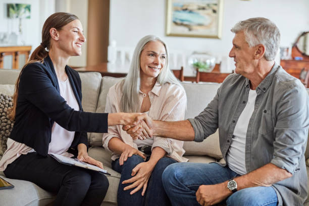 istock Couple with confident insurance agent at home 1344767741