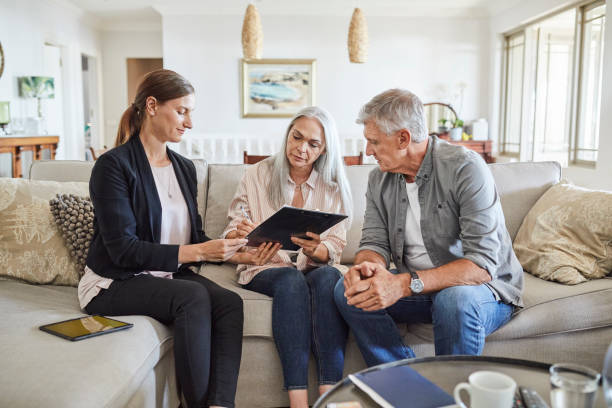 istock Mature couple with insurance agent at home 1344768020