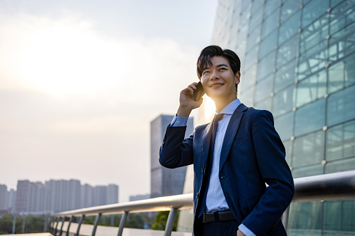 Young Asian businessmen are on the phone