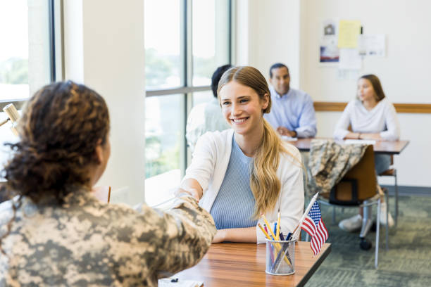 istock Soldier congratulates young woman when recruiting paperwork done 1344768733