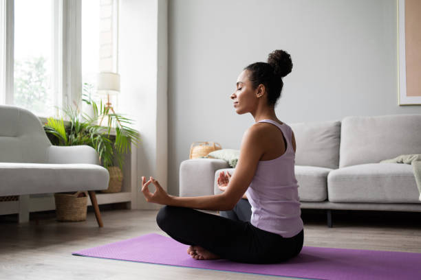 istock Woman practicing yoga, meditating at home 1344769368