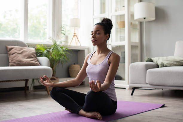 istock Woman practicing yoga, meditating at home 1344769384