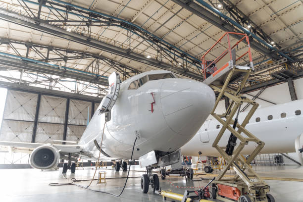 istock Big white plane in hangar during repair 1344771279