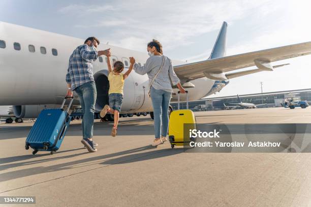 Happy Family In Masks Enjoying Travel Together Stock Photo - Download Image Now - Travel, Family, Vacations