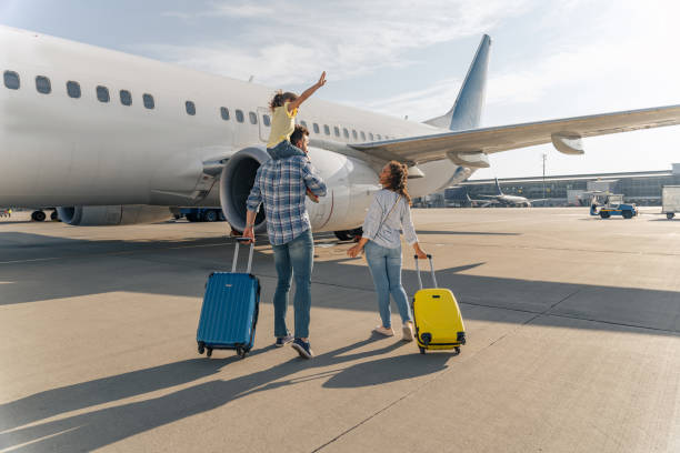 istock Dad holding his daughter on his shoulders and mom next to them 1344771295