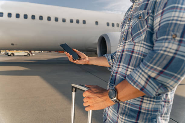 istock Male passenger holding a smartphone and a comb before the flight 1344771307