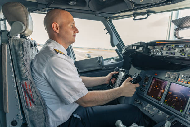 istock Confident pilot sitting in the cockpit and holding the steering wheel 1344771320