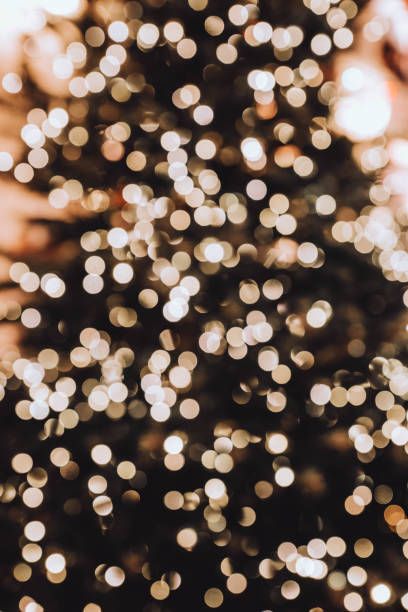istock Golden blurry Christmas bokeh lights. Defocused holiday background. 1344771607