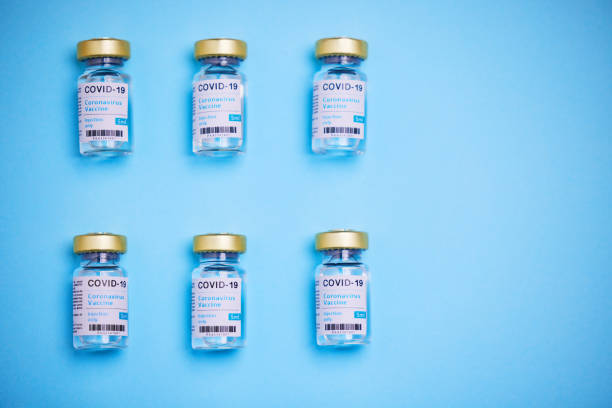 istock Studio shot of vaccine tubes against a blue background 1344772265