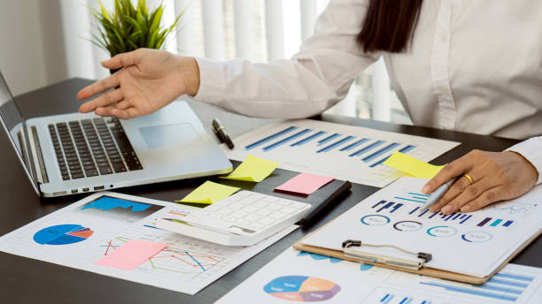 istock Accountant or Financial Auditor, Reporting, Computing, Home Finance, Investing, Economy, Savings, Businessman or Financial Professional. Analyze graphs, business reports and financial charts at the company office. financial economy concept banking busines 1344772407