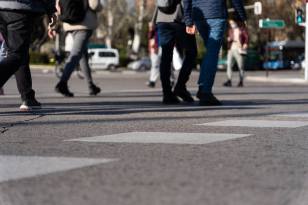 istock Unrecognizable people walking at the zebra crossing 1344772721