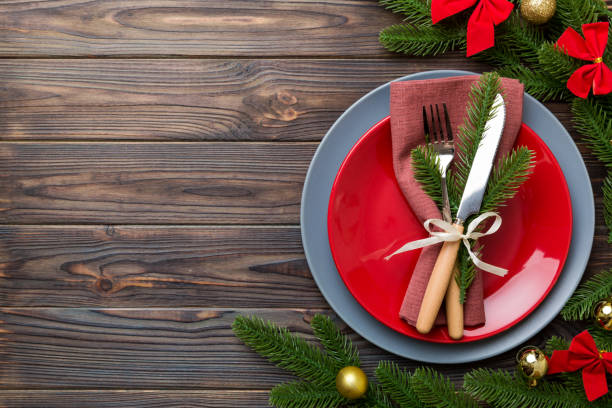 istock Christmas table place setting with christmas decor and plates, kine, fork and spoon. Christmas holiday background. Top view with copy space 1344775735