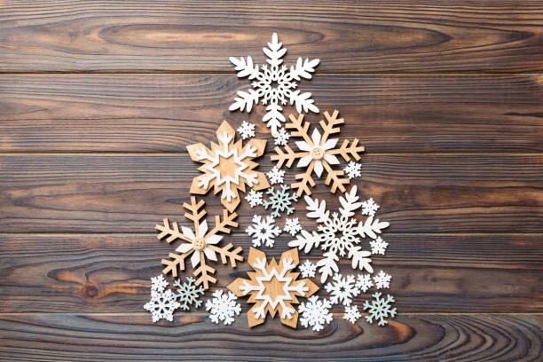 istock Christmas tree made from colored handmade ball decoration on colored background, view from above. New Year minimal concept with copy space 1344775748