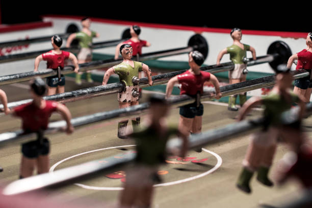 Foosball table game with red and green players