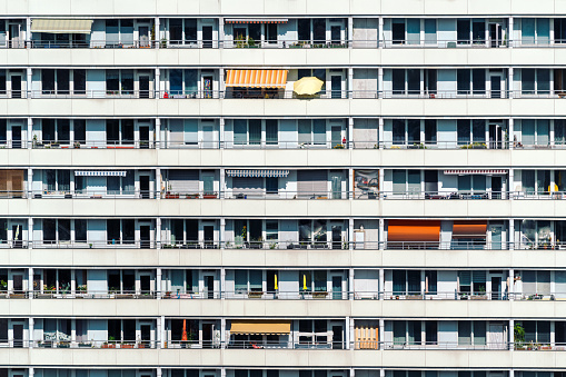 Residential building view in Berlin. Facade of a big apartment building with small balconies.