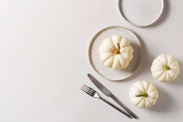 istock Thanksgiving, harvest and halloween setting table on white 1344777395