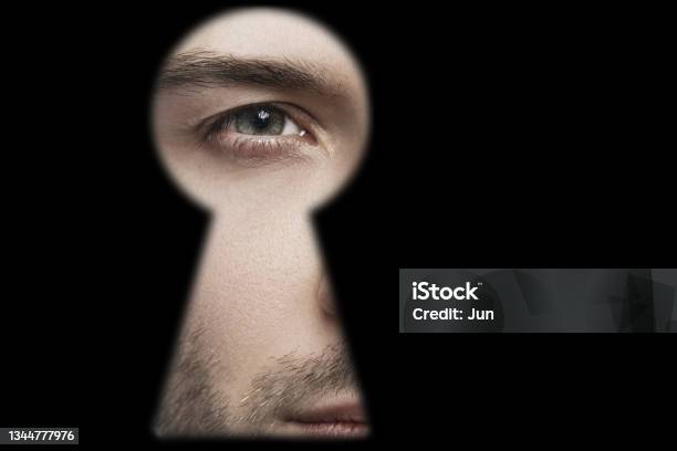 Male Eye Looking Into The Keyhole Stock Photo - Download Image Now - Surveillance, Keyhole, Spy