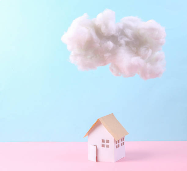 istock Cloud and house model on blue-pink pastel background. Concept art. Minimalism 1344779392