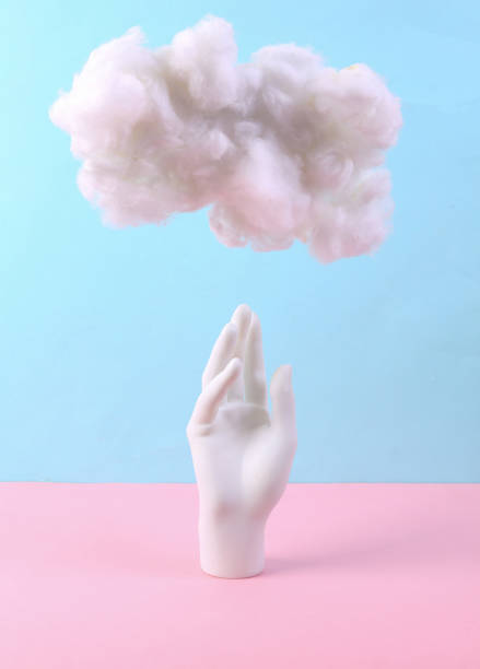 istock Stand hand with cloud on pastel pink blue background. Creative idea. Minimal concept. Pastel color trend 1344779403