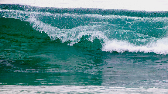 Turquoise Cresting Glass Wave in Malibu Surf in Malibu, California, United States