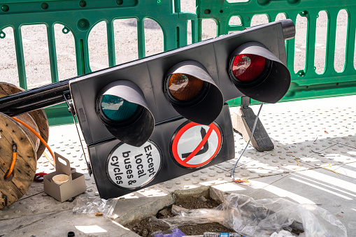 A set of traffic lights on the street during roadworks in London, UK.