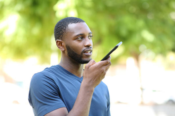 istock Black man dictating audio message on smart phone 1344781554