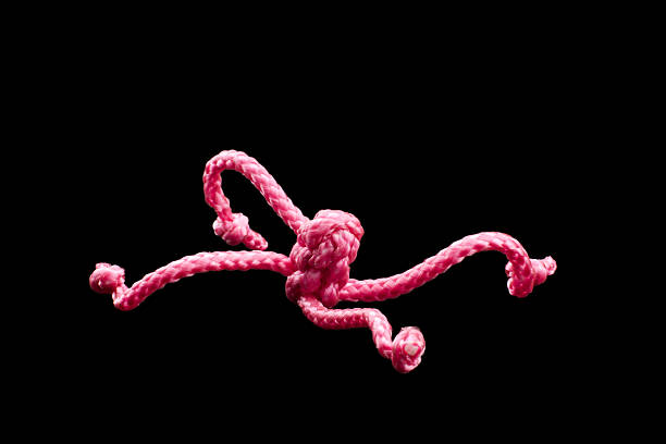 istock Pink twine and knots, isolated on black 134478171