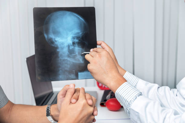 Medical and health care  concept. Doctor explaining x-ray results to patient while sitting at the table in office. stock photo