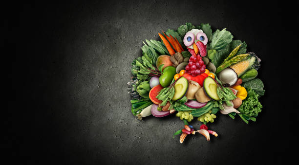 Vegan Thanksgiving Vegan thanksgiving turkey and funny vegetarian autumn harvest symbol as vegetables fruit nuts and berries shaped as a festive gobbler for a holiday celebration on a black background as a composite. funny thanksgiving stock pictures, royalty-free photos & images