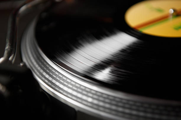 istock Vinyl record with music on turntable player. Retro dj turn table device playing musical tracks in hi fi quality 1344787456